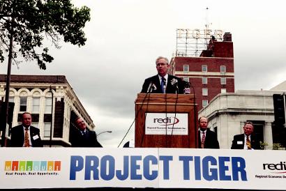 REDI Chairman Dave Griigs, IBM Senior Vice President Tim Shaughnessy, Mayor Bob McDavid and former Mayor Darwin Hindman listen as Gov. Jay Nixon speaks during the IBM announcement May 17.