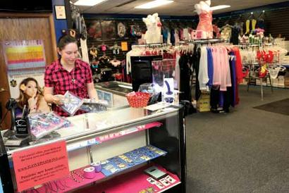 Krystina Lively organizes merchandise at Passion's adult bookstore.
