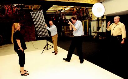 From left, owners Lisa Adams-Lloyd, Dale Lloyd, Art Smith and Jack Stanley practice studio lighting techniques in their 2,400-square-foot photography studio.
