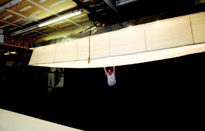 Art Smith moves his 22-footlong soft box that he built out of copper piping and fabric. It's used to light cars and large objects.