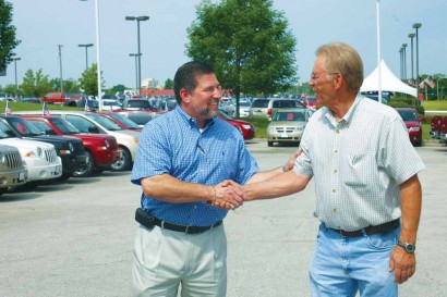 Dan Burks of University Chrysler thanks Gene Winn for coming back to his dealership to shop for a new truck.