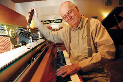 Frank Hennessy finely tunes a recently sold Yamaha piano at his shop, Hennessy and Sons Music. After 35 years of business, the music store will close June 30.