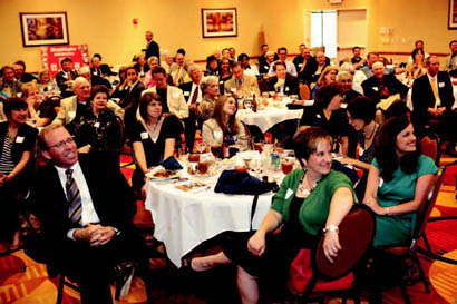 Attendees of the 2010 Chamber annual meeting enjoy a slideshow paying tribute to retiring Chamber Chair Byron Hill.