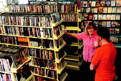 Owner Janet Marsh talks with a customer about movie choices.