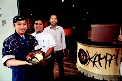 From left, Sam Tuankrua, Tony Sudsai and Art Wuttisak show off the Kampai roll at Kampai Sushi Bar & Restaurant located in Alley A.