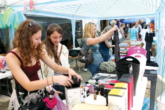Shoppers check out the deals during the Dog Days Sidewalk Sale downtown July 29-Aug 1.
