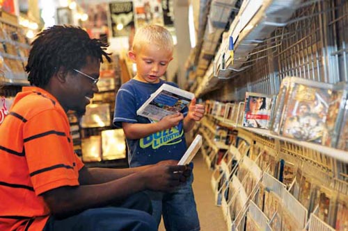 Clarence Young and his stepson Gage Hunter pick out a new video game at Slackers