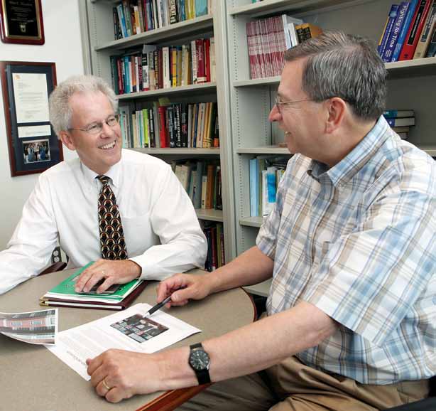 Dean of the College of Business Bruce Walker goes over a report with Associate Dean Allen Bluedorn. After serving as dean for 20 years, Walker will become a faculty member in the Department of Marketing this fall.