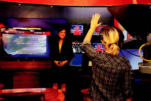 Production Assistant Cara Blome gives Chief Meteorologist Sharon Ray a five second warning during her ABC 17 Stormtrack 24/7 weather update.