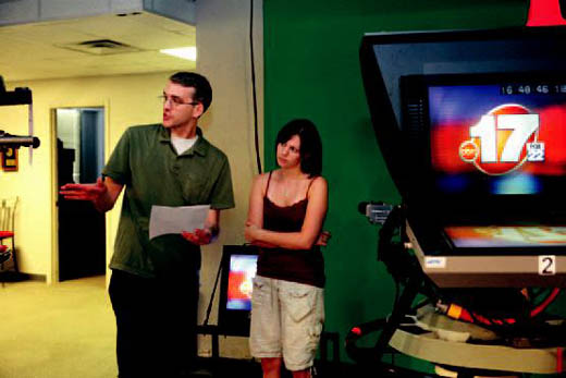 Production Assistant Hana Duckworth takes directions on camera placement for the premiere of the 5 p.m. news.