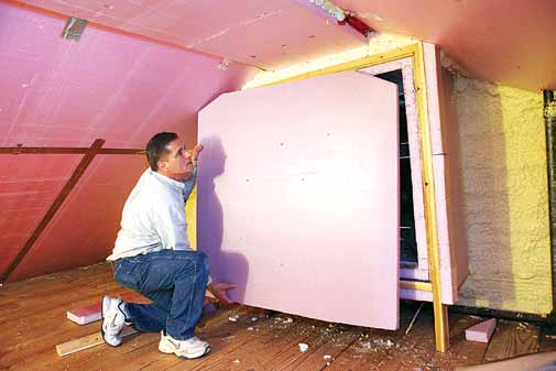 Mike Priest of Maranatha Energy Saving Renovations installs a cap for the attic fan in Mari Ann Bihr's house. "If you don't insulate the house fan, it's a major energy loss on the home," Priest said. "Air sealing a home can easily save 20 percent on energy bills."