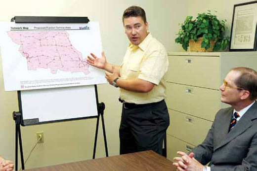 Chris Martin presents the proposed Missouri route for BlueBird Media's broadband services to Scott Gibson III, head of school for Columbia Independent School.