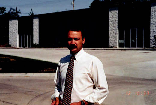 Archive photo of Randy Coil in front of the Blueridge Industrial Building (circa 1987).