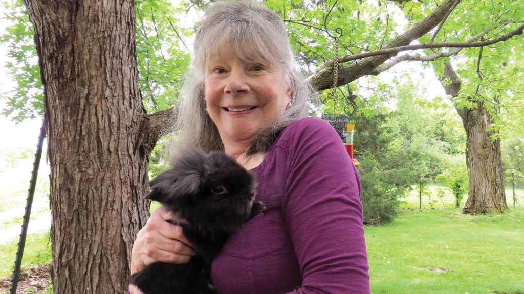 Peg Schrader holding a rabbit