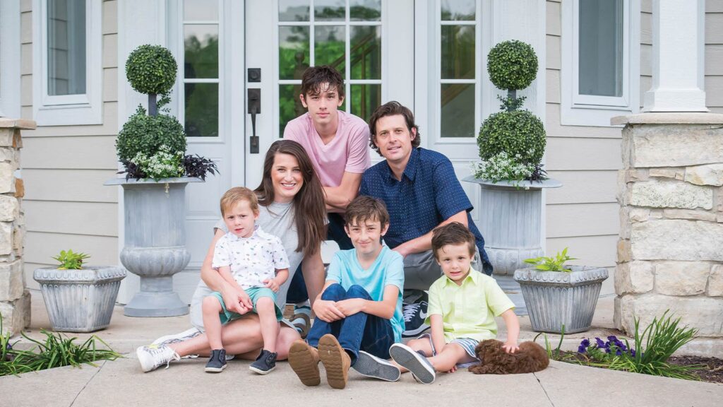 The Cornell family of Columbia on their front porch posing for the Front Door Project