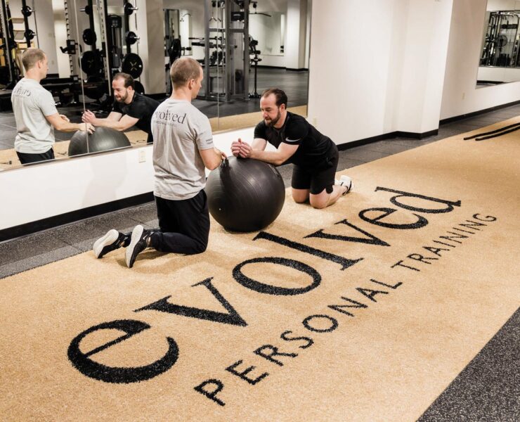 Personal trainer assisting at Evolved Personal Training in Columbia, MO
