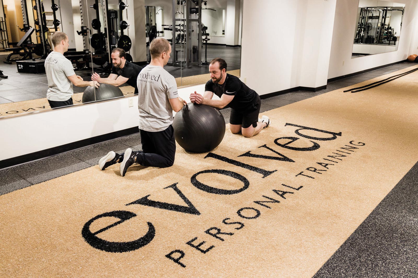 Personal trainer assisting at Evolved Personal Training in Columbia, MO