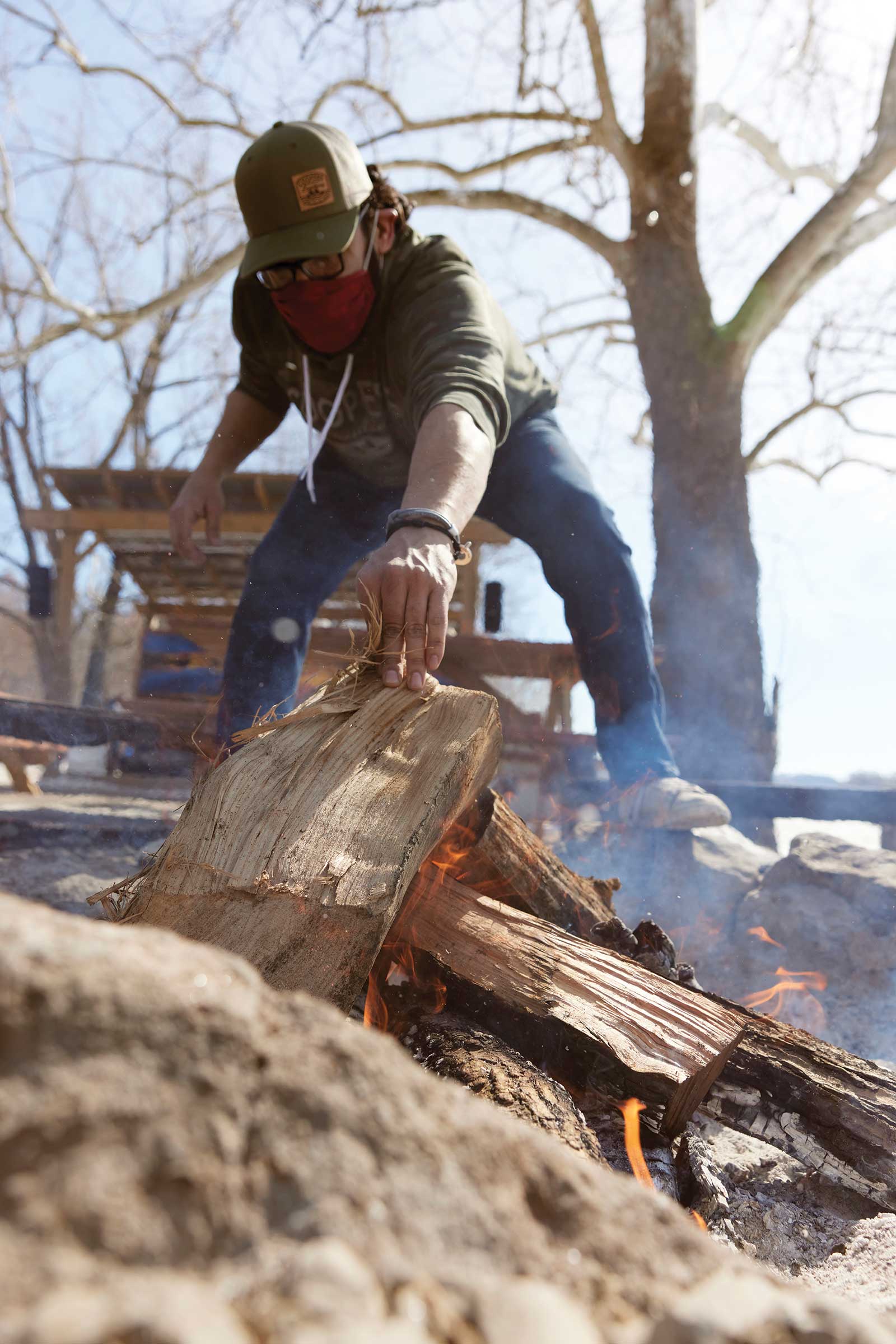 Michael De Leon builds a fire at Cooper's Landing on the Missouri River