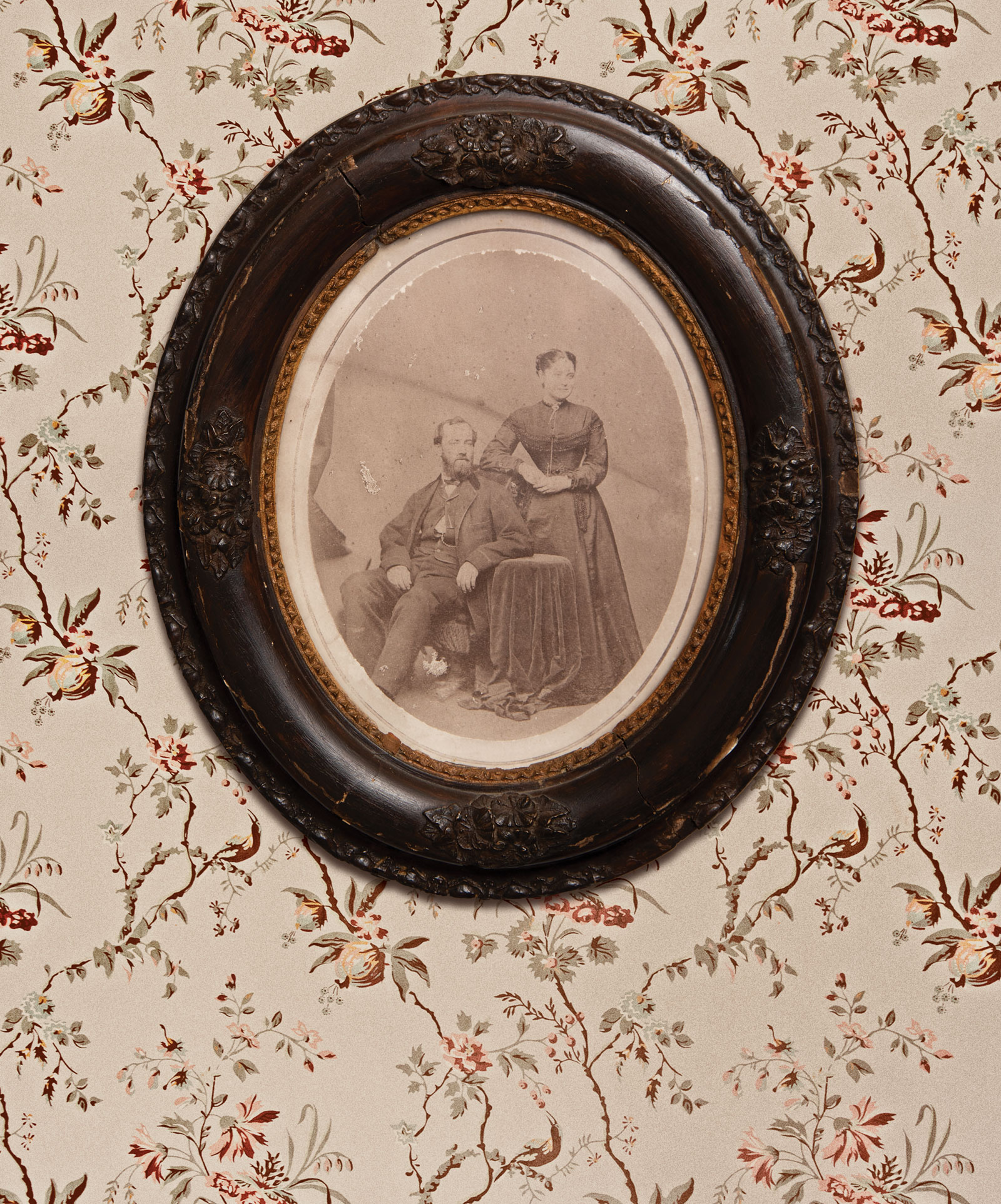 Portrait-of-Sanford-and-Kate-Conley-in-Oval-vintage-frame-hanging-on-floral-wallpaper.
