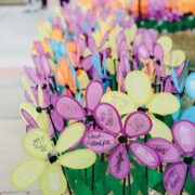 close up of fake flowers written on by various people for particiapting in a charity alzhemiers event