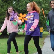 Three young women particiapting in a charity alzhemiers walk