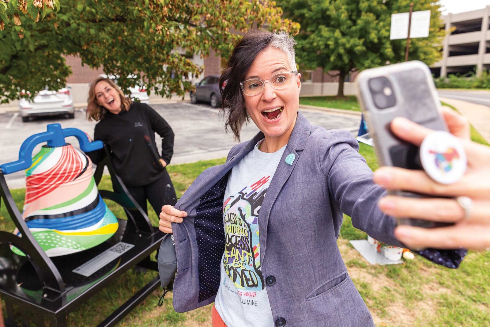 Shelly-Farnen-takes-a-selfie-with-the-bell-and-Meg-Wagler-behind-her