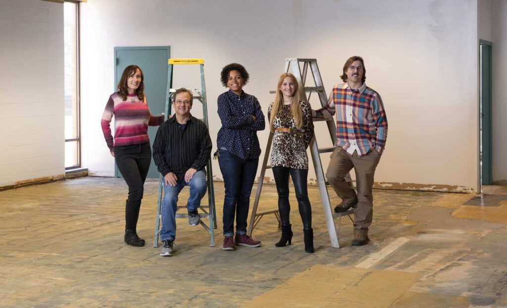 Close up of compass board of directors pose in a construction site