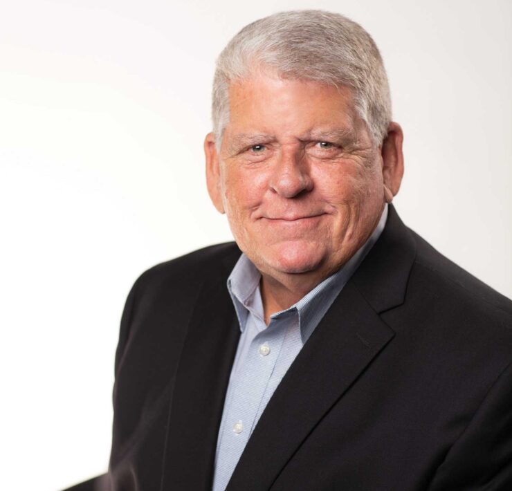 Headshot of a man in a suit named Randy Minchew against a white wall