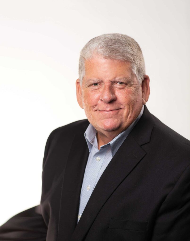 Headshot of a man in a suit named Randy Minchew against a white wall