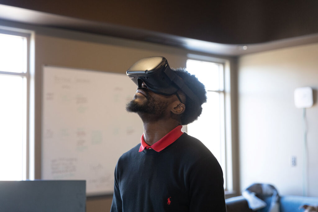 close up of a man wearing a virtual reality headset over his eyes looking up at the ceiling