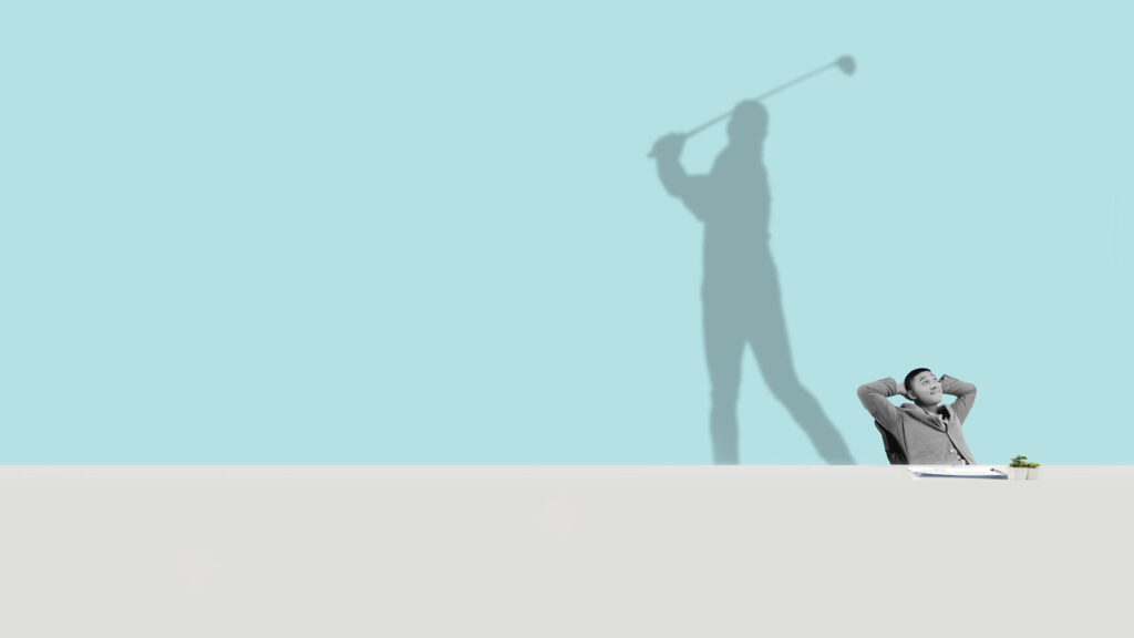 man sitting at a desk with shadow of him playing golf behind him against a pale blue background