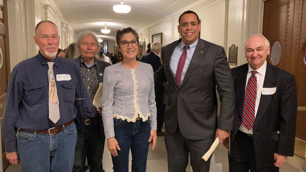 members of a conservation group pose with state representative member inside of a government building