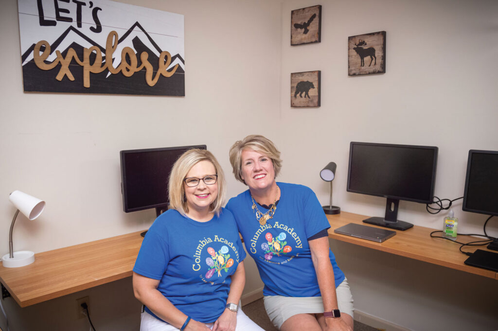 Two instructors inside of a computer lab