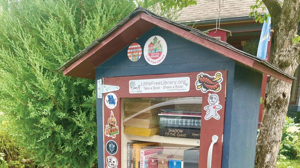 Close up of an exterior view of a little free library stand stocked with books