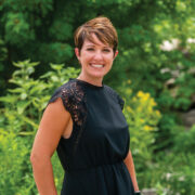 Headshot of a women named Krista Kippenberger standing in a garden