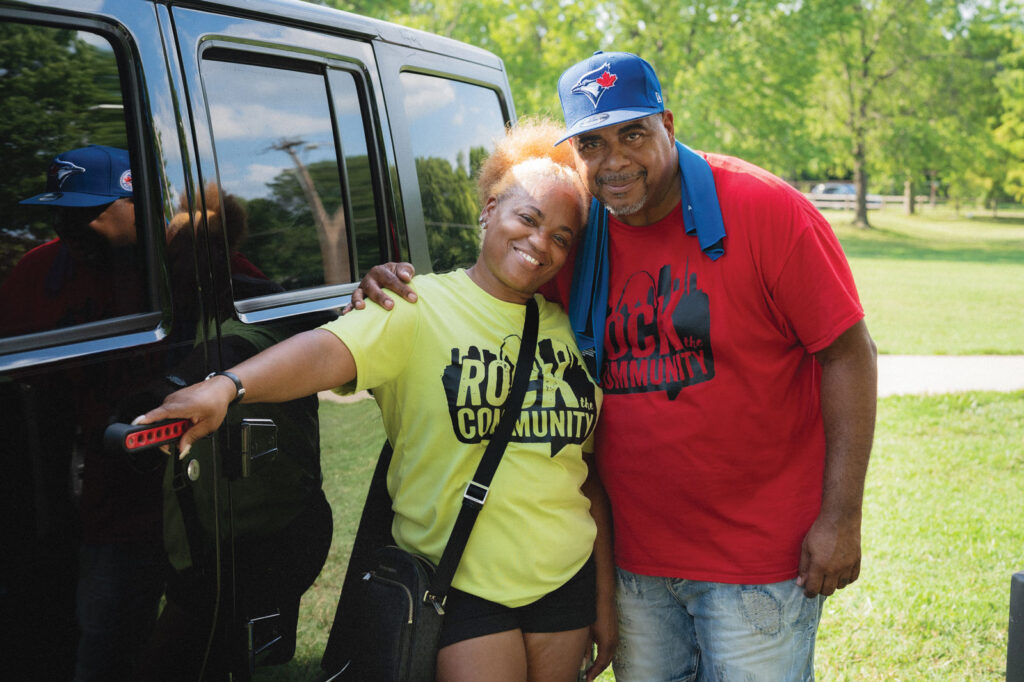 Rita Renee and Rodney March embrace one another outside by a black car