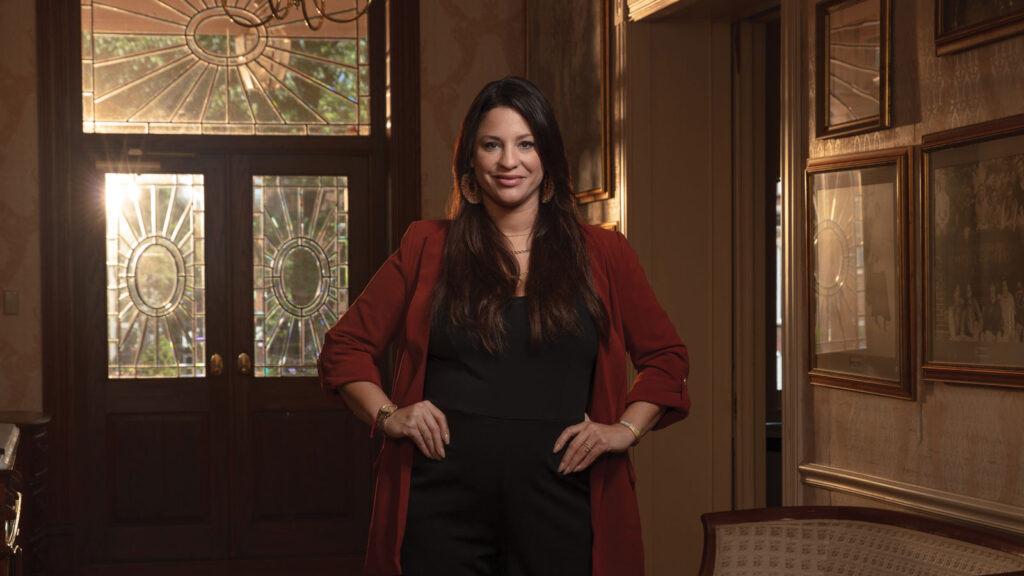 Close up headshot of a women named Elizabeth Herrera standing in the foyer of a house