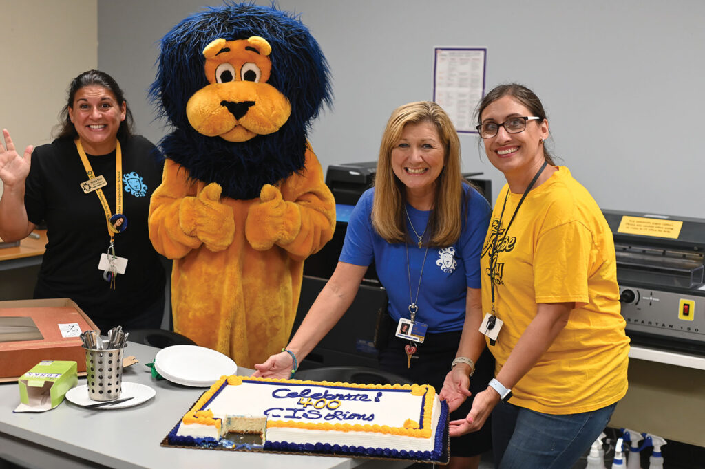 CIS employees and mascot celebrating the enrollment of its 400th student