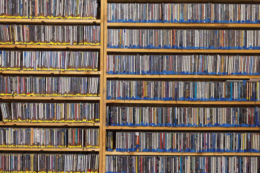 a filled shelf of music at KOPN