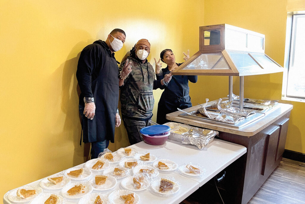 volunteers behind the pie table serving hot food