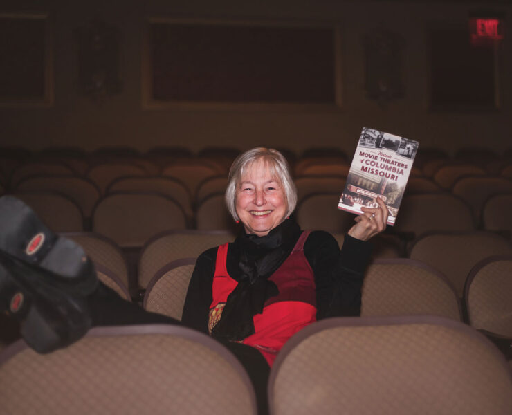 Dianna Borsi O’Brien holding her book, Historic Movie Theaters of Columbia, Missouri