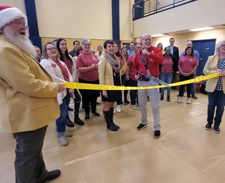 The Columbia Chamber of Commerce ambassadors, with VAC Executive Director Ed Stansberry, cut the ribbon to launch VAC's 39th annual gift program.