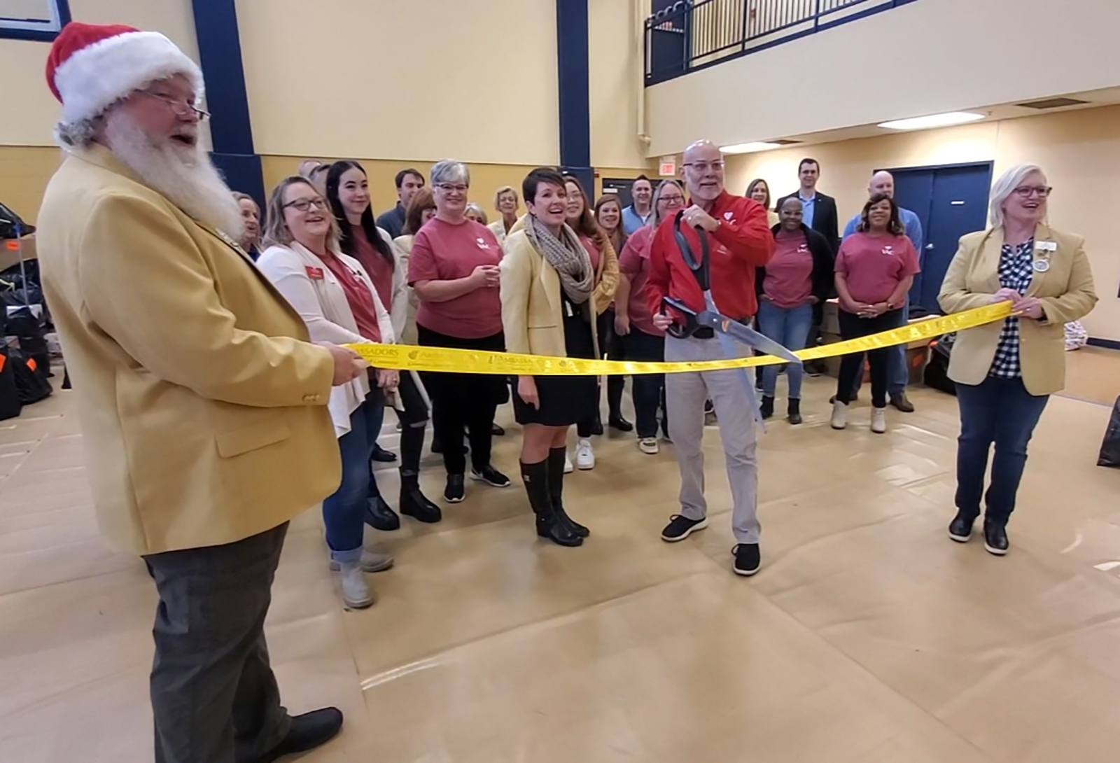 The Columbia Chamber of Commerce ambassadors, with VAC Executive Director Ed Stansberry, cut the ribbon to launch VAC's 39th annual gift program.