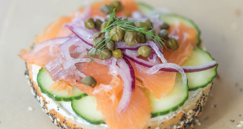 extreme close up shot of Yenta with Lox on an Everything Bagel served on a vintage blue and white China plate at Goldie's Bagels