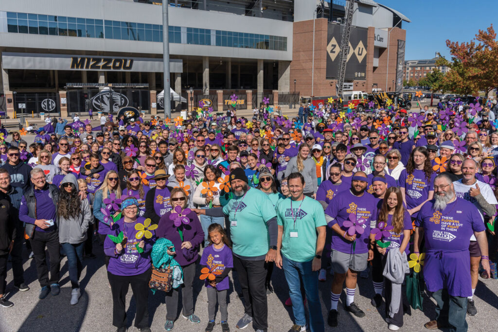 A large amount of volunteers and community members participating in the Walk to End Alzheimer's community event outside of the Mizzou Faurot Field