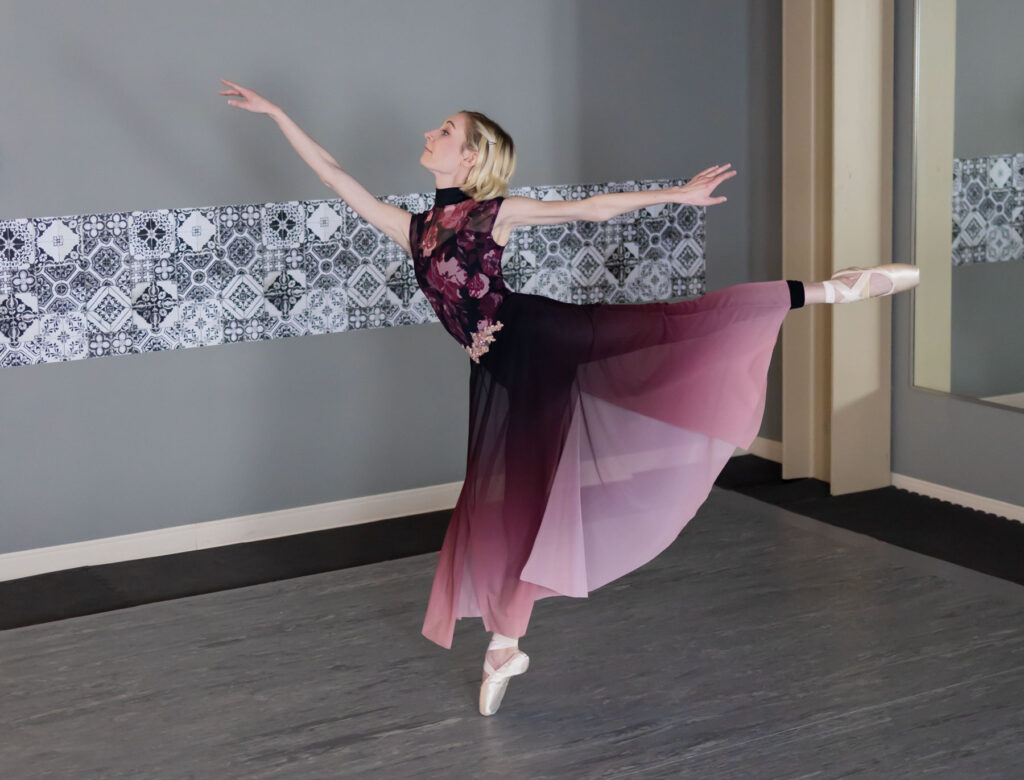 Emmy Mertens preforming a ballet inside of a dance studio