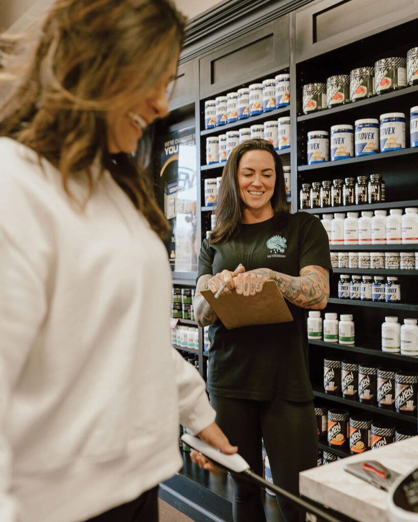 Interior of Nutrishop storefront showcasing stocked shelves and workers ready to help