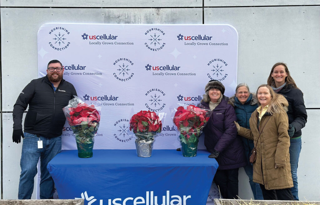 US Cellular booth with employees. Company contributed a significant donation to the community