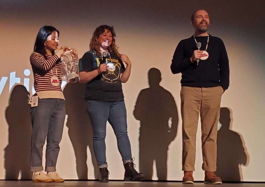 Angel Ellis, center in photo, was the recipient of the True Life Fund at the 2023 True/False Film Fest in Columbia, Missouri. Angel appears on stage after the third screening of the film Bad Press on Sunday, March 5, 2023, at the Missouri Theatre.