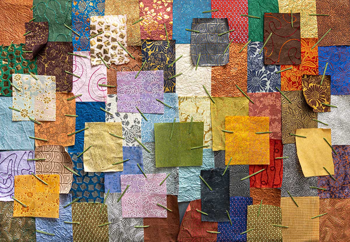 An old quilt with blocks stitched together to illustrate an upcoming event about quiltmaking.